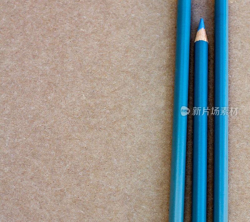 Three blue pencils - one sharpened, with copy space